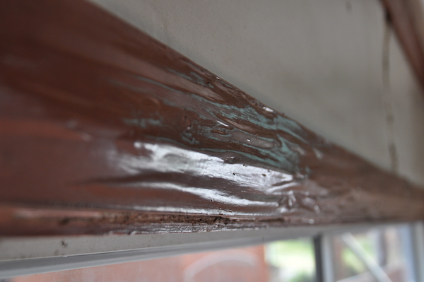 Termite damage hidden behind rippled paint